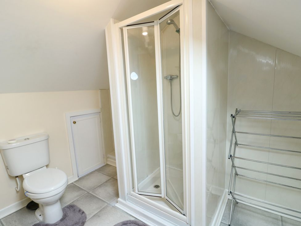A bathroom with a shower and toilet at Getws in Ty Croes