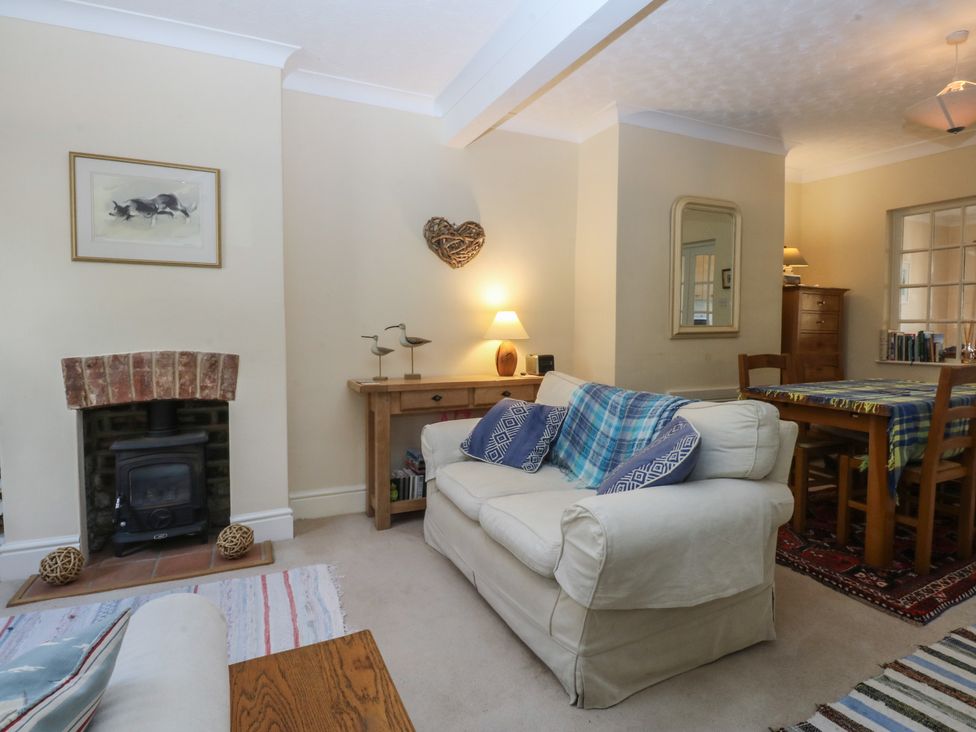 A living room with a sofa and dining table at 15 Rose Hill Beaumaris