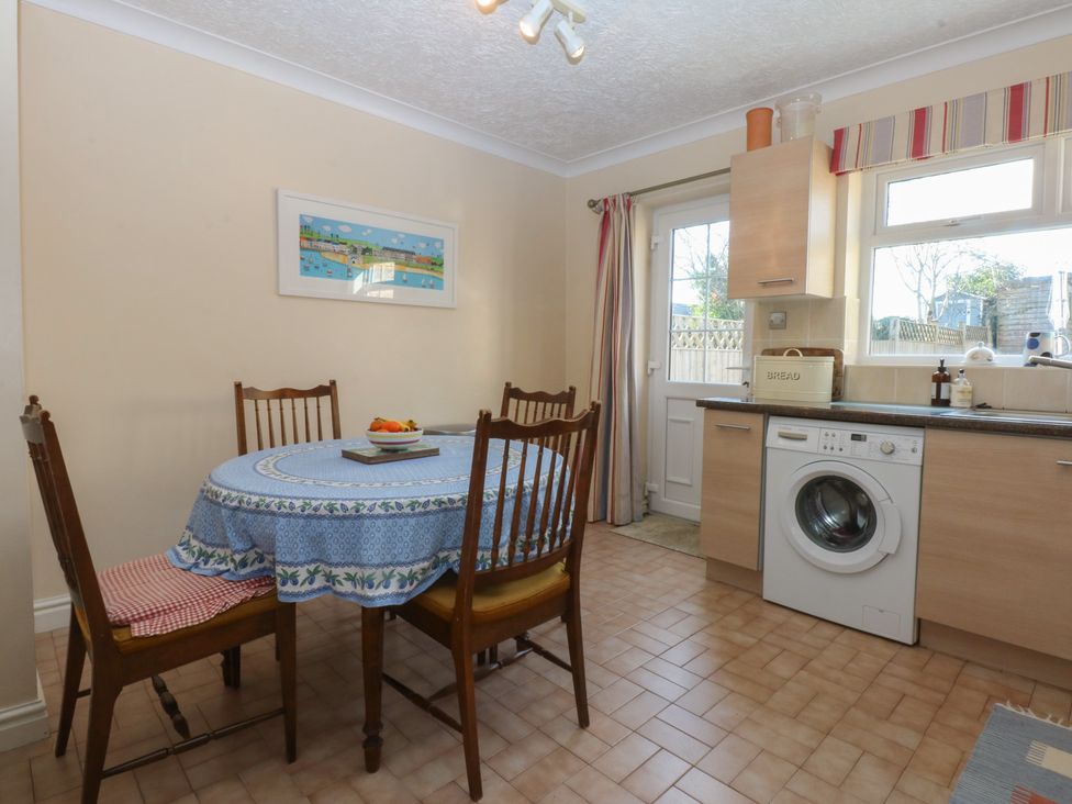 A kitchen with a table and chairs at 15 Rose Hill Beaumaris