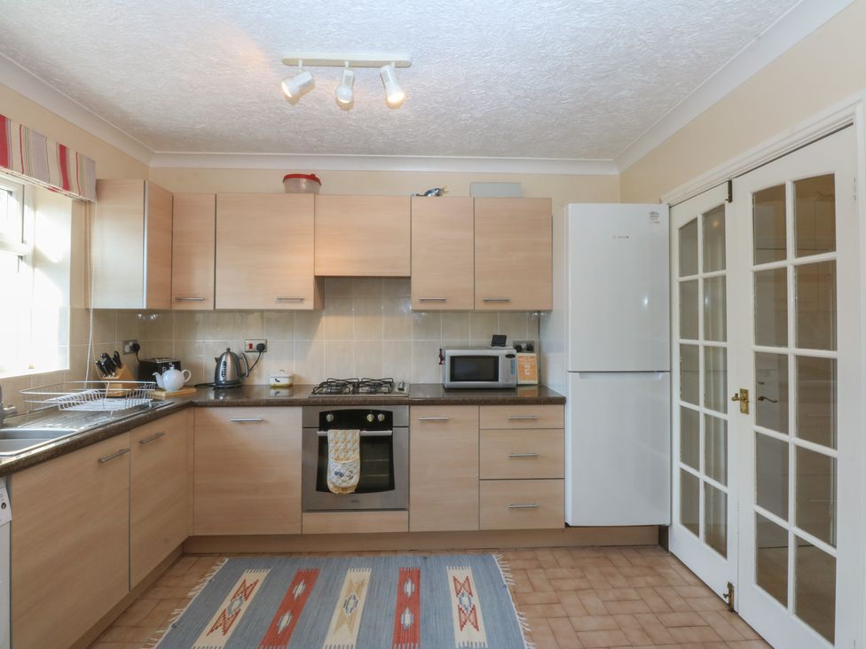 A kitchen with cabinets and appliances at 15 Rose Hill Beaumaris