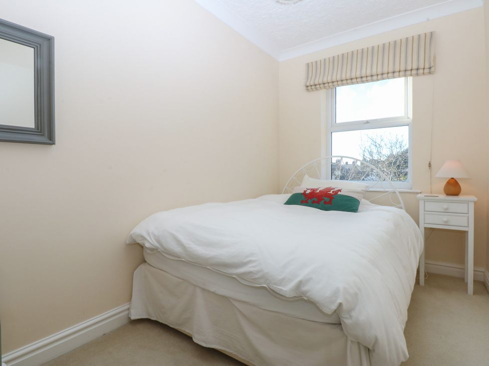 A bedroom with a bed and nightstand at 15 Rose Hill Beaumaris