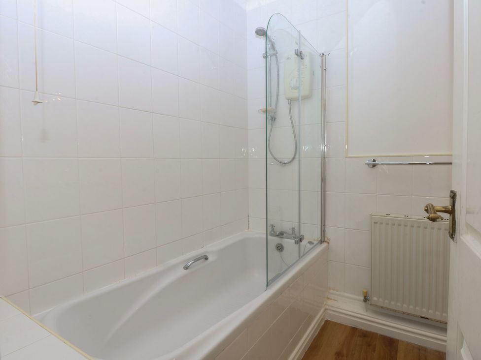 A bathroom with a tub and shower installation at 15 Rose Hill Beaumaris