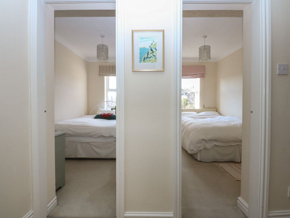 A view of two bedrooms with beds and a picture frame at 15 Rose Hill Beaumaris