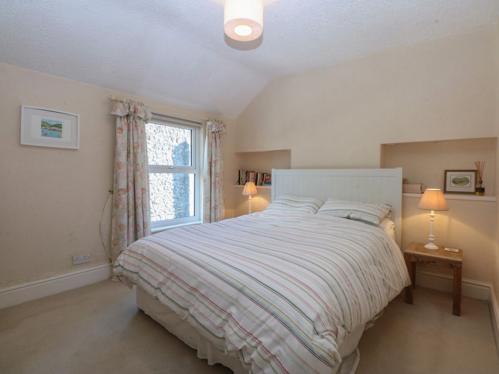 A bedroom with a bed and bookshelf at 15 Rose Hill Beaumaris