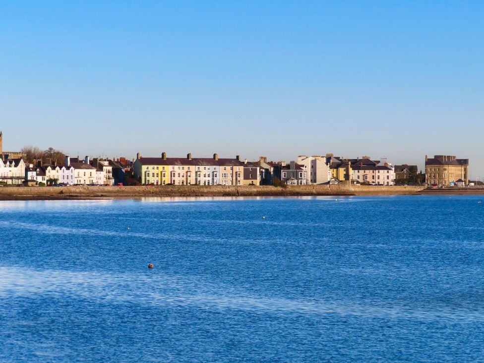 A view of buildings along the shore by water at 15 Rose Hill Beaumaris