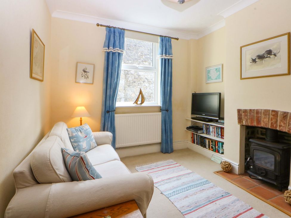 A living room with a sofa and television at 15 Rose Hill Beaumaris