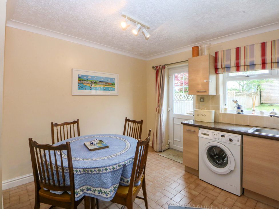 A kitchen with a table and chairs at 15 Rose Hill in Beaumaris