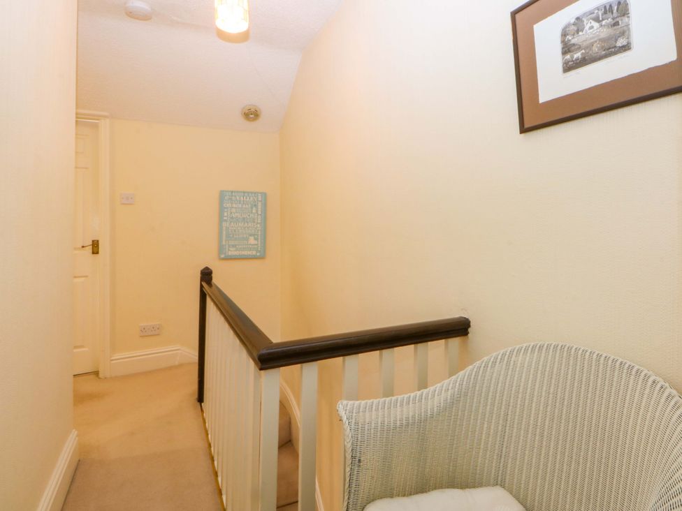 A hallway with stairs and a seating area at 15 Rose Hill Beaumaris