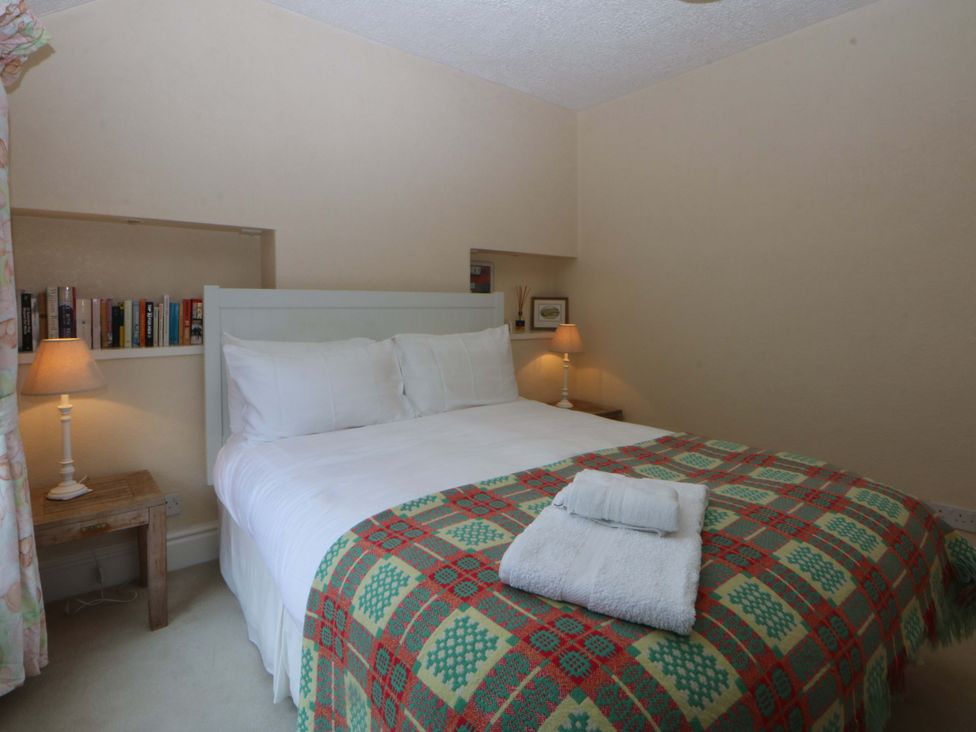 A bedroom with a bed and nightstand at 15 Rose Hill Beaumaris