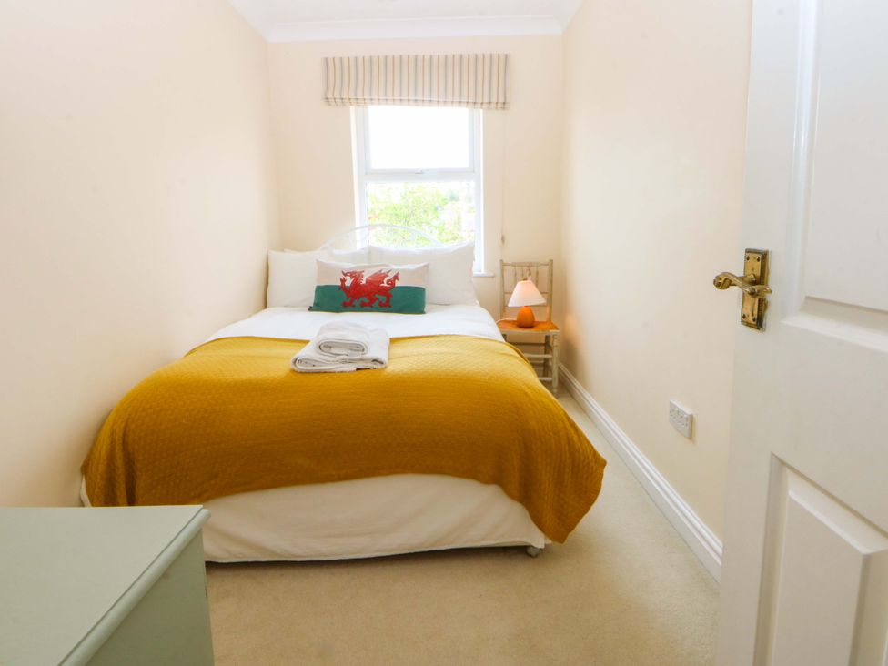A bedroom with a bed and window at 15 Rose Hill Beaumaris