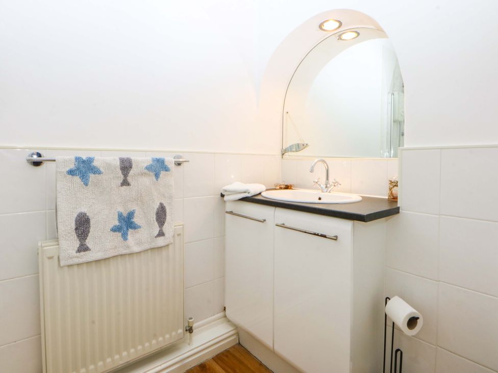 A bathroom with a sink and mirror at 15 Rose Hill Beaumaris