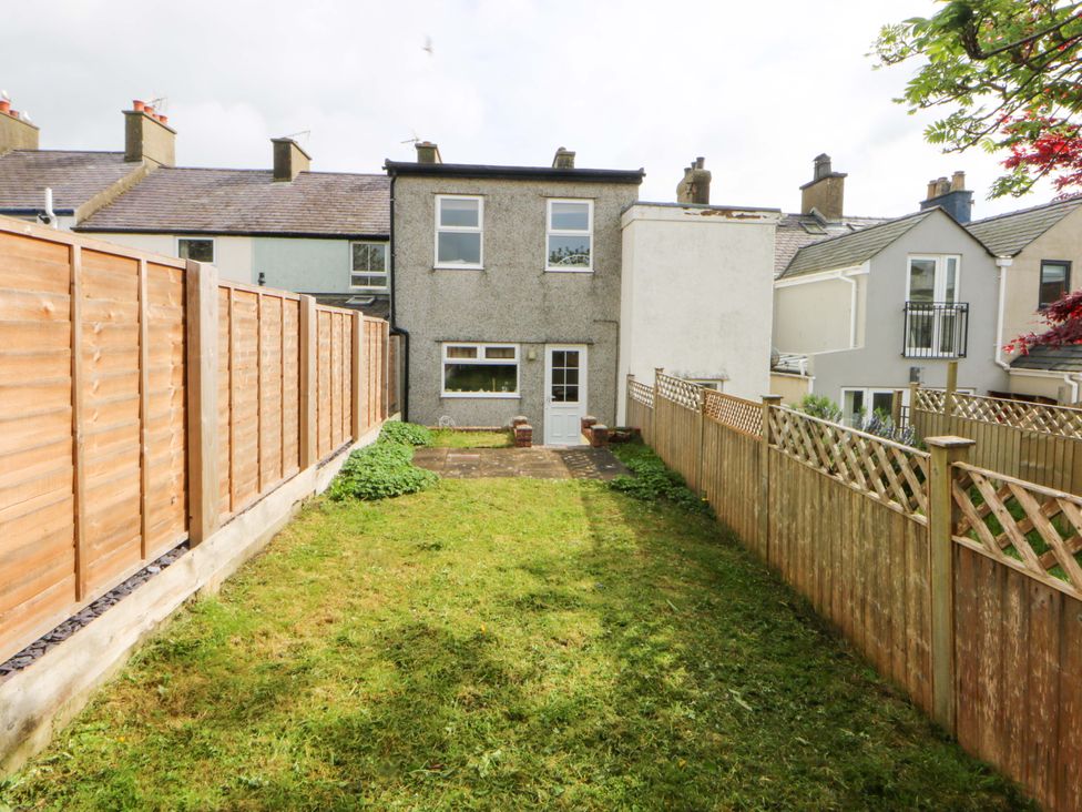 A backyard with a house and fence at 15 Rose Hill Beaumaris