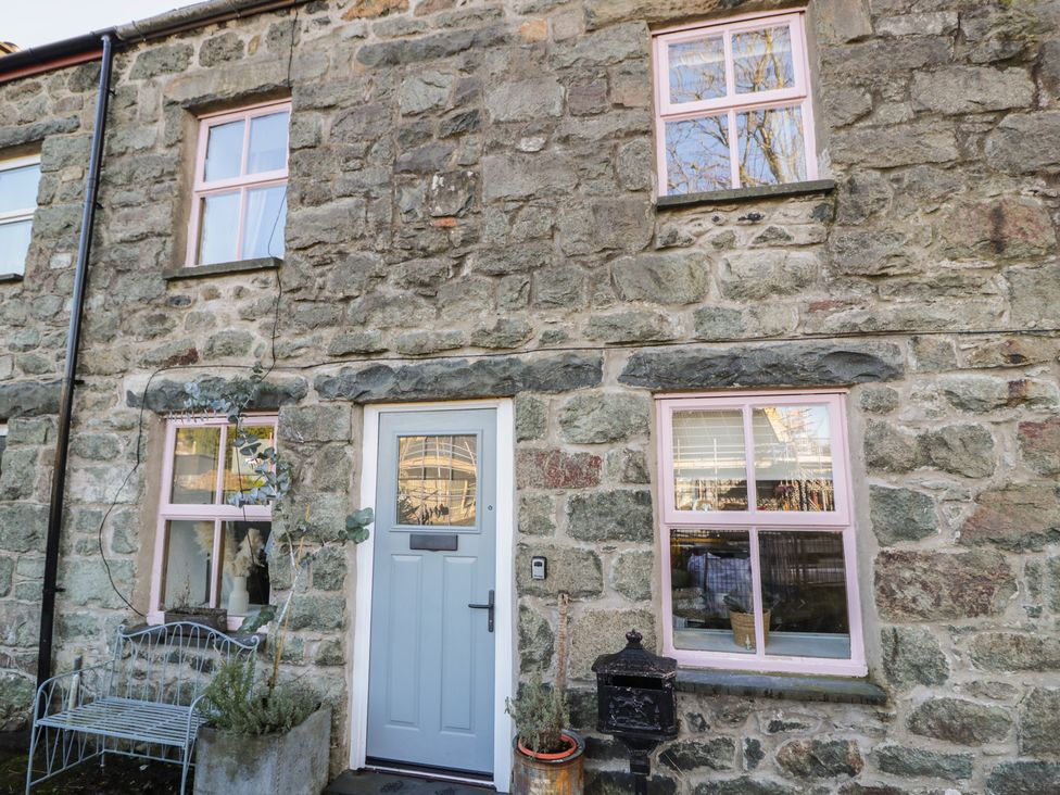 A stone facade with windows and door at Lon Popty in Dolgellau