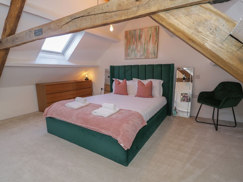 A bedroom with a bed and furniture at Lon Popty in Dolgellau