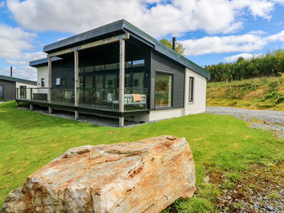 A house with a deck and glass railing at Strathview