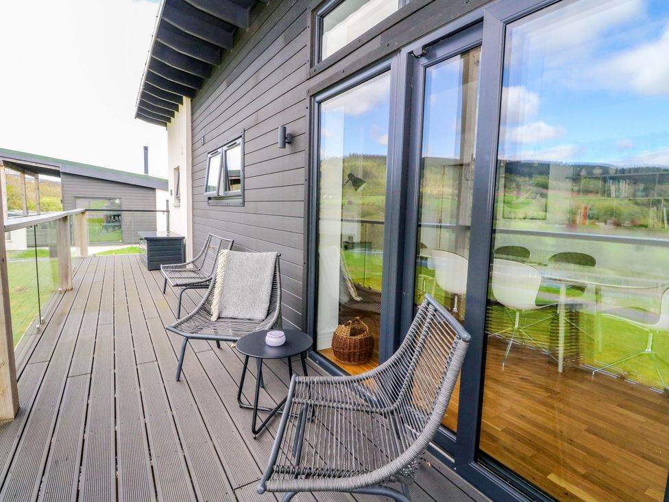 An outdoor patio with chairs and a table at Strathview