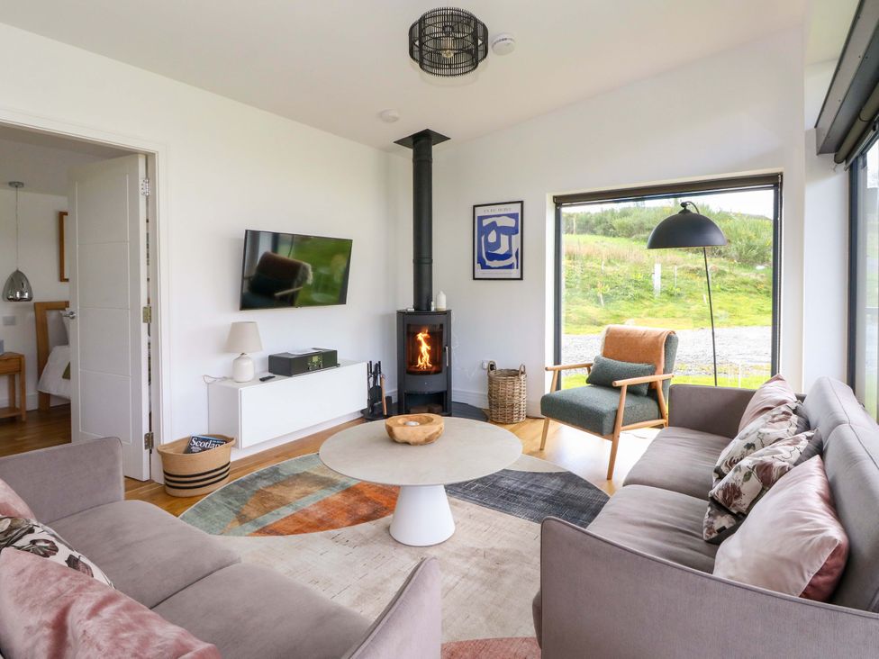 A living room with a sofa and fireplace at Strathview