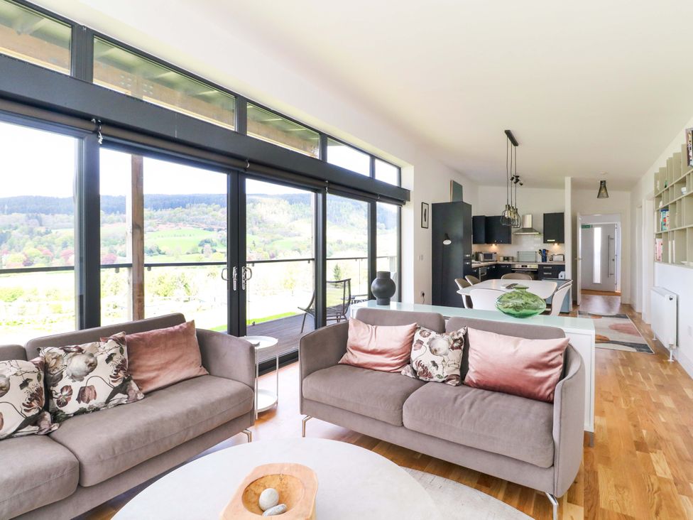 A living room with seating and open kitchen at Strathview