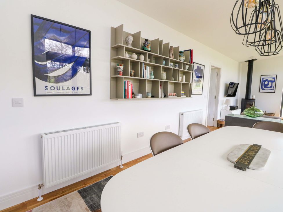 A dining room with a radiator and shelves at Strathview