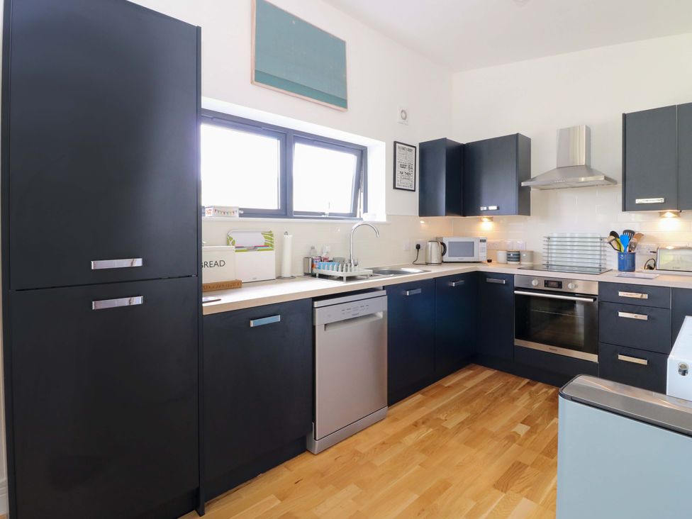 A kitchen with appliances and cabinets at Strathview 