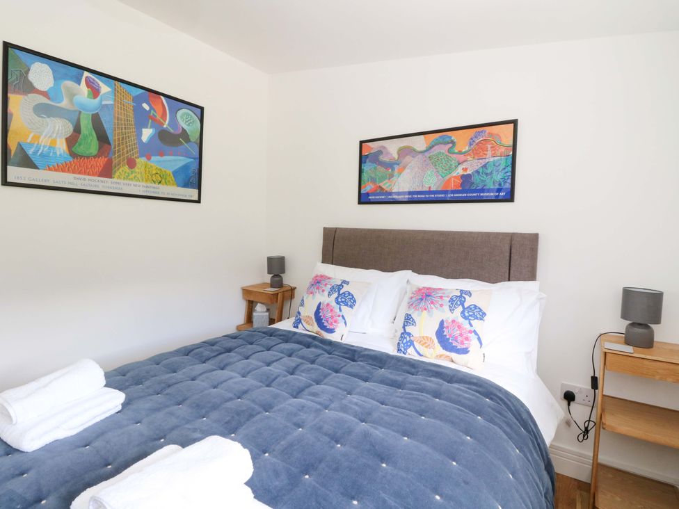 A bedroom with a bed and wall art at Strathview