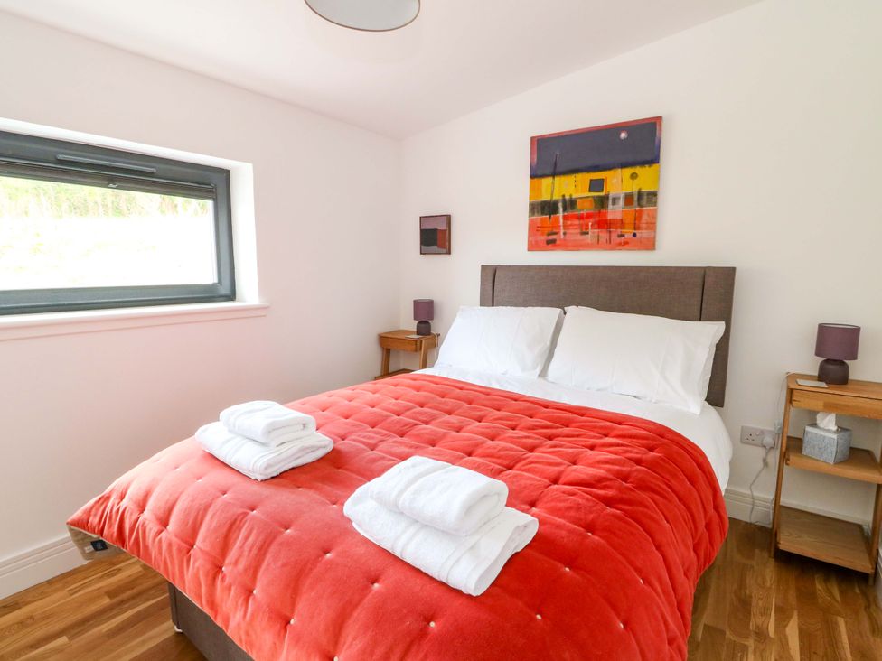 A bedroom with a bed and artwork at Strathview