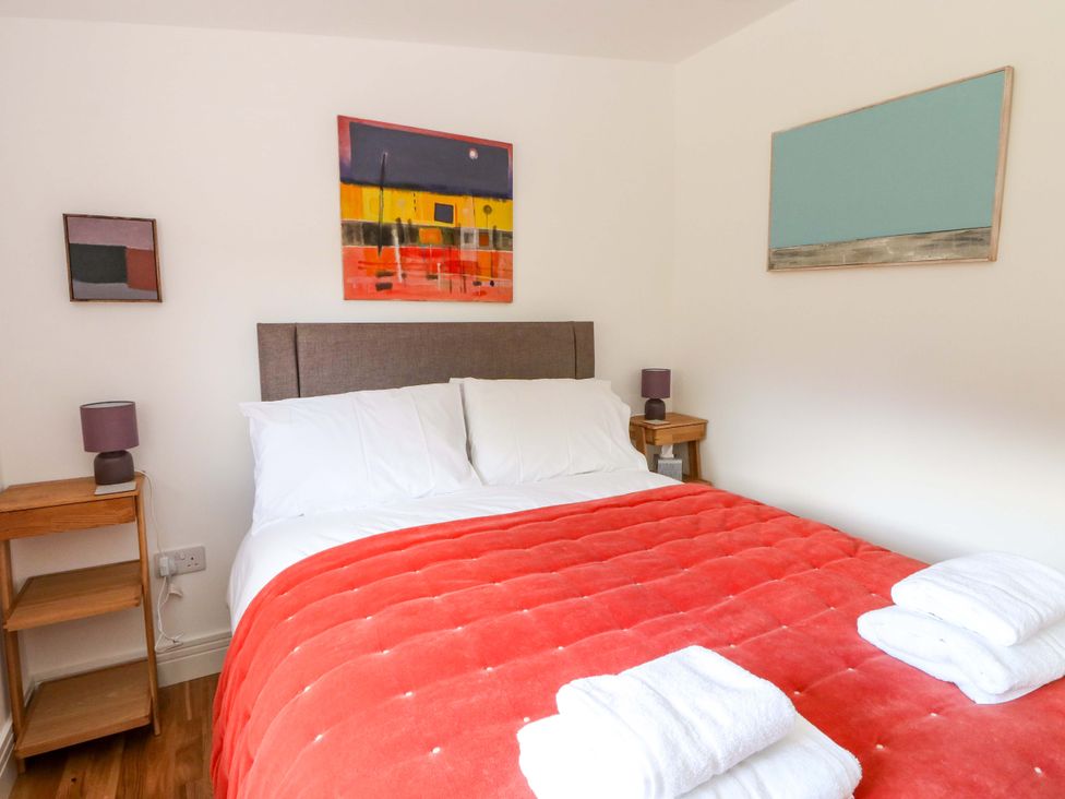 A bedroom with a bed and artwork at Strathview