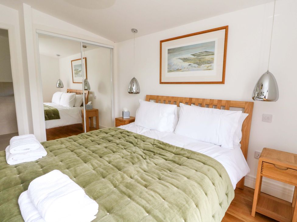A bedroom with a bed and bedside table at Strathview