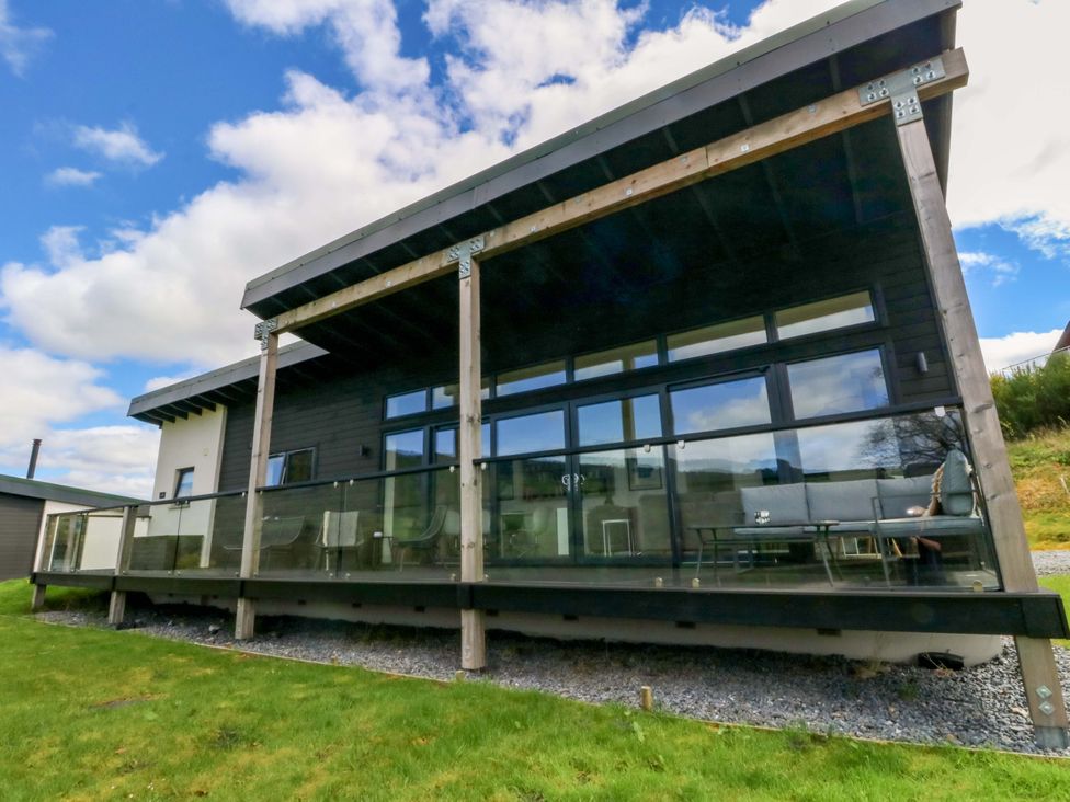 A house with a deck and glass railing at Strathview 