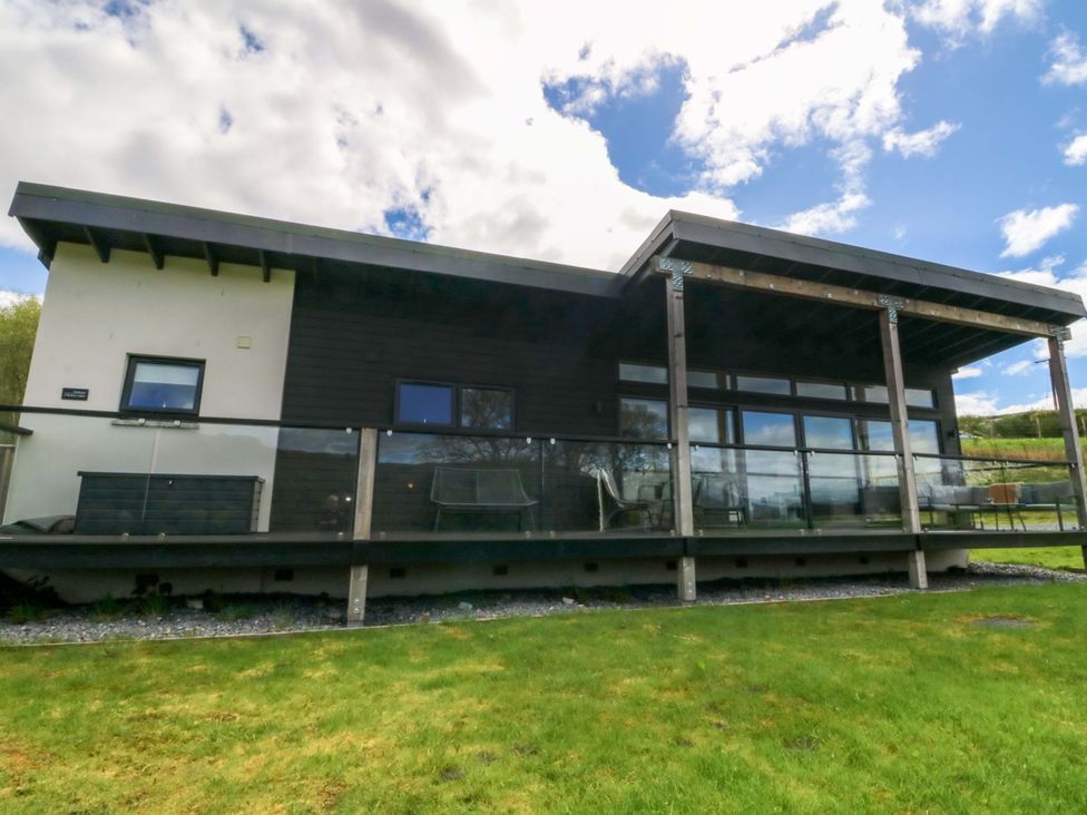A house with a deck and glass railing at Strathview