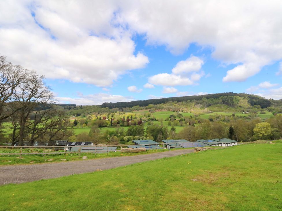 A view of a field with trees and buildings at Strathview