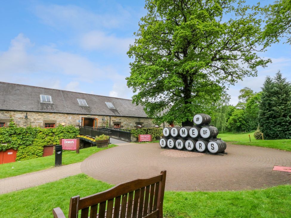 An outdoor area with barrels sign at the Home of Dewars