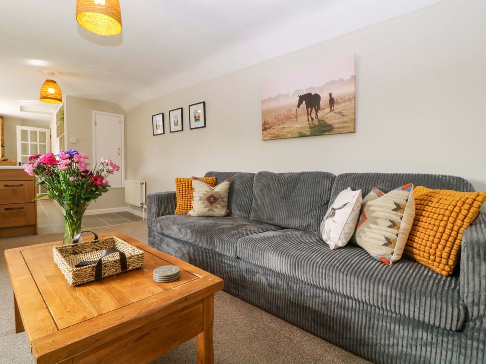 A living room with a sofa and coffee table at Farm View Annex in Painswick
