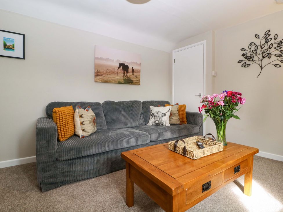 A living room with a sofa and coffee table at Farm View Annex Painswick