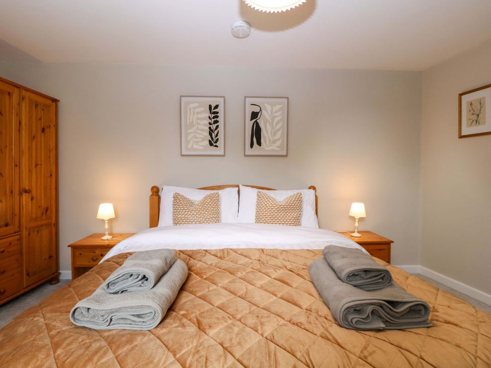 A bedroom with a double bed and wardrobe at Farm View Annex in Painswick