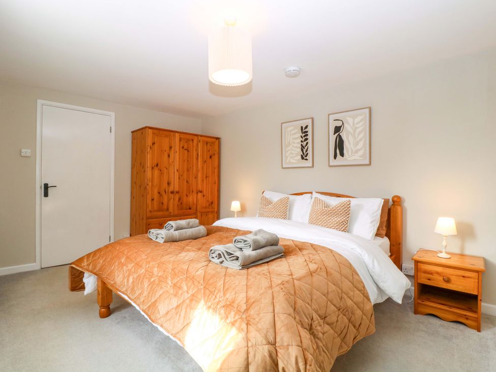 A bedroom with a bed and dresser at Farm View Annex in Painswick