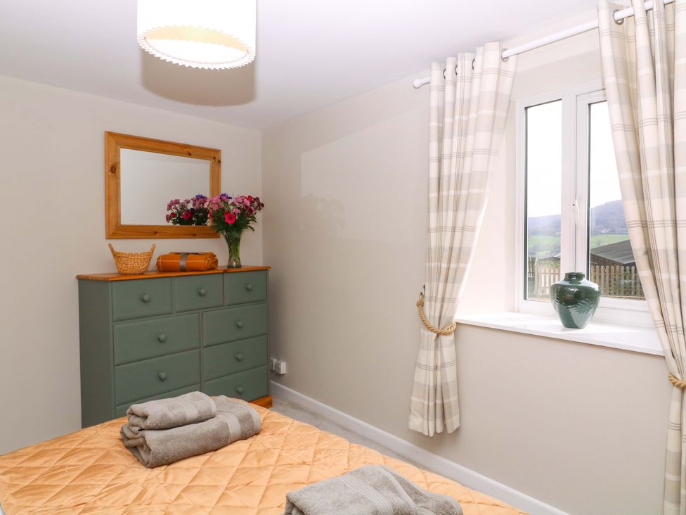 A bedroom with a dresser and window at Farm View Annex in Painswick