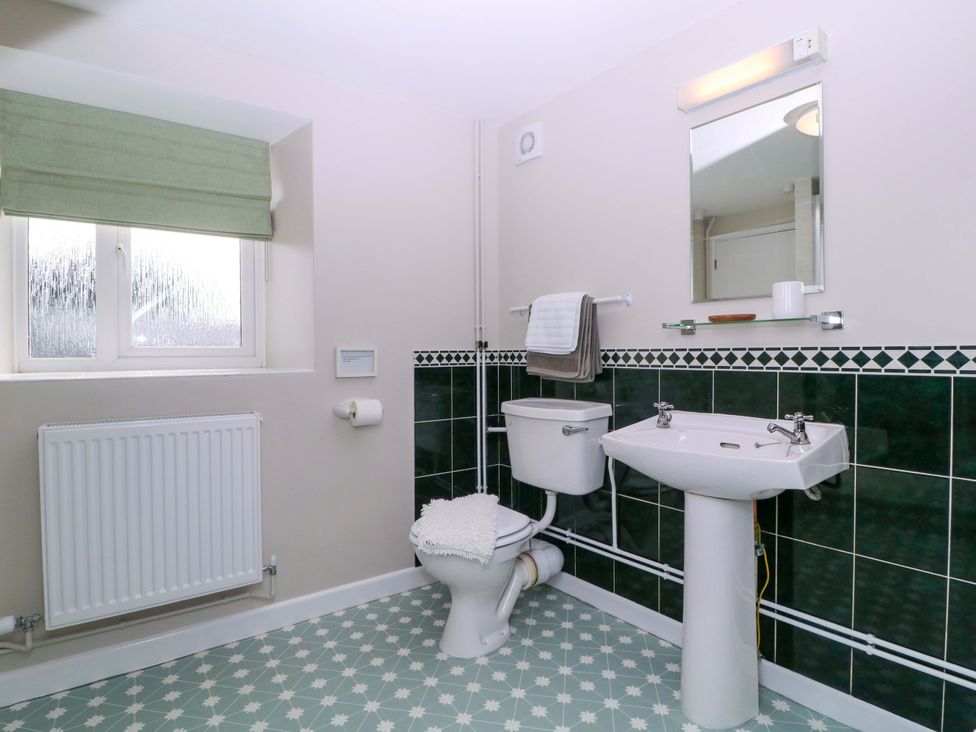 A bathroom with a sink and toilet at Farm View Annex in Painswick