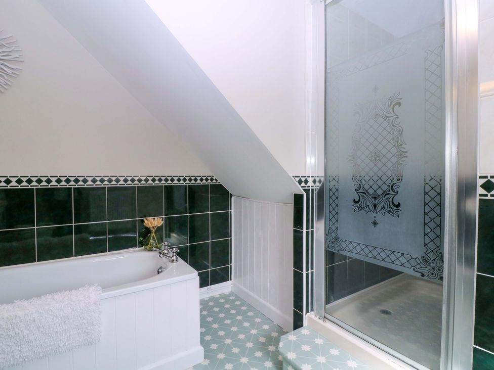 A bathroom with a bathtub and shower at Farm View Annex in Painswick