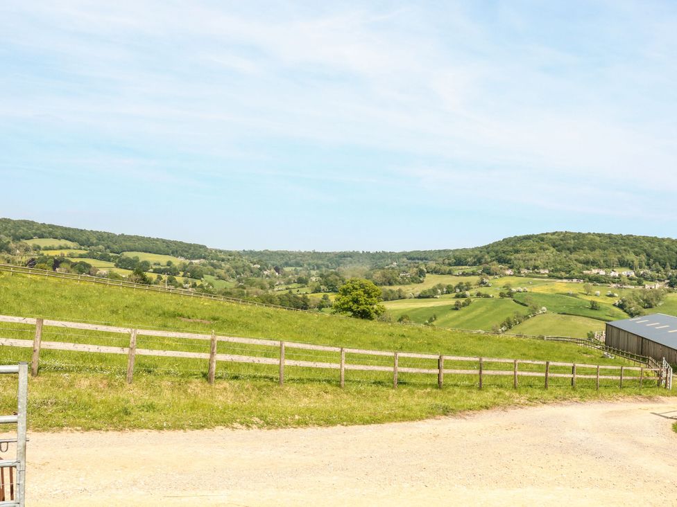 A view of hills and fields with a fence and shed at Farm View Annex in Painswick
