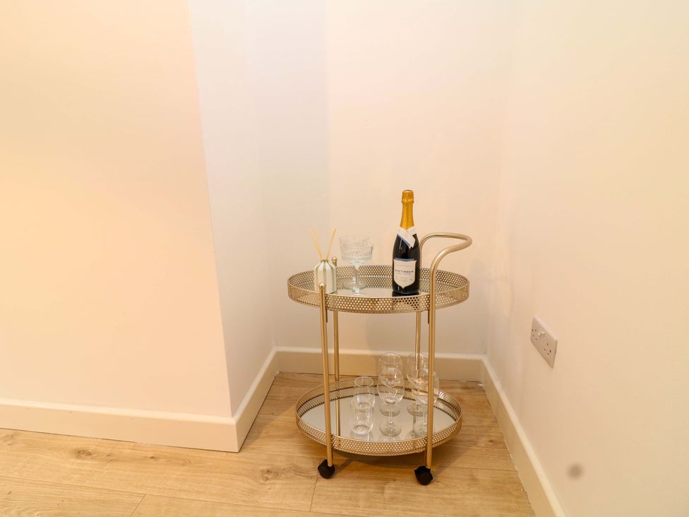 A bar cart with champagne and glassware at 14 Crown terrace Belper