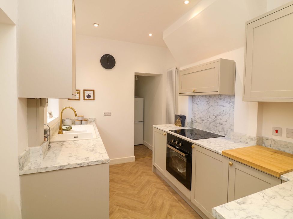A kitchen with cabinets, a sink, and a countertop at 14 Crown terrace Belper