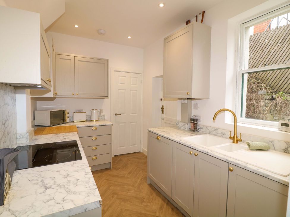 A kitchen with cabinets and a sink at 14 Crown terrace in Belper