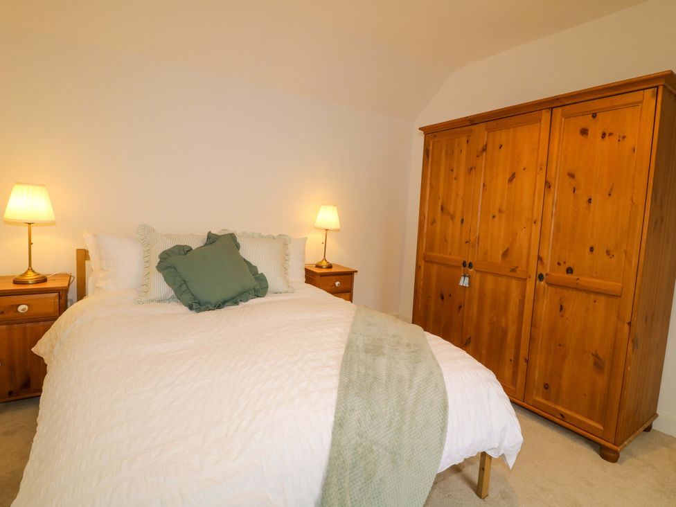 A bedroom with a bed and wardrobe at 14 Crown terrace, Belper