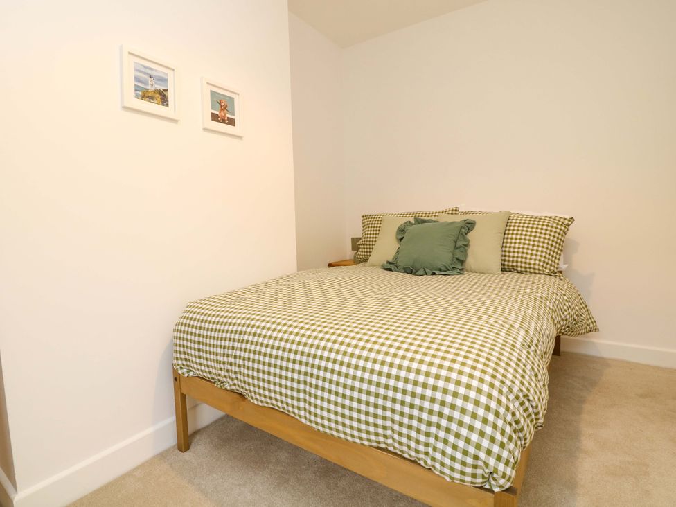 A bedroom with a bed and pictures on the wall at 14 Crown terrace Belper