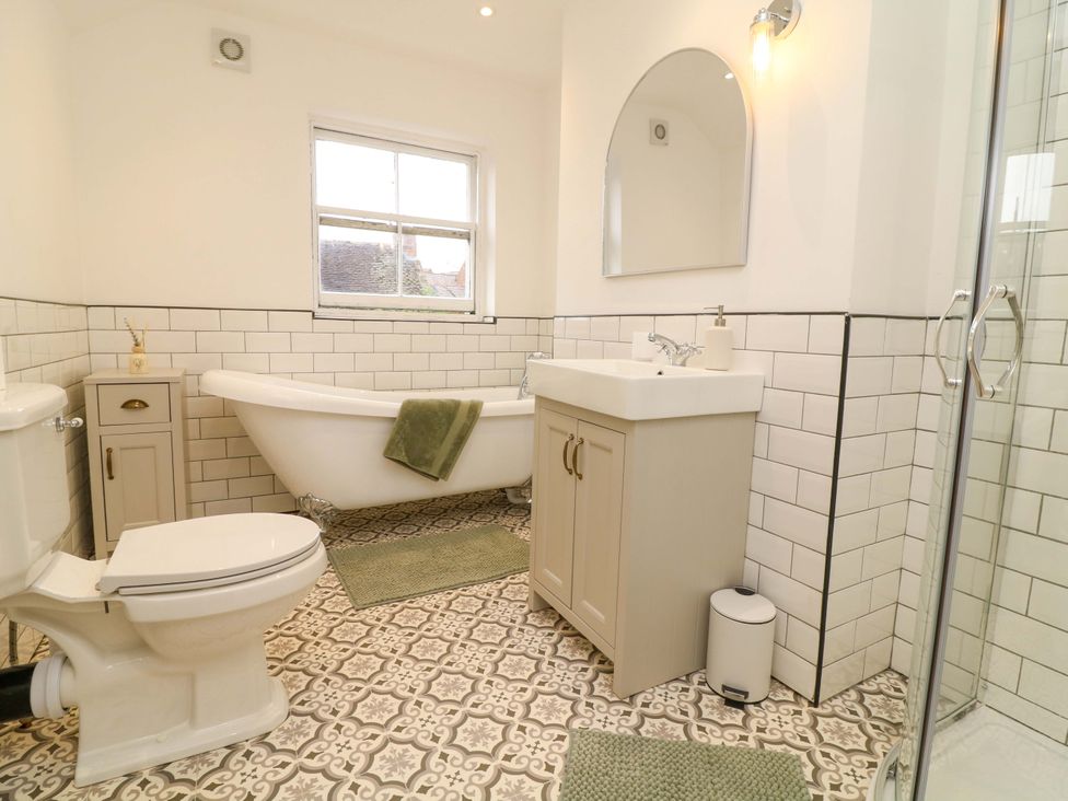 A bathroom with a bathtub, toilet, sink and shower at 14 Crown terrace in Belper