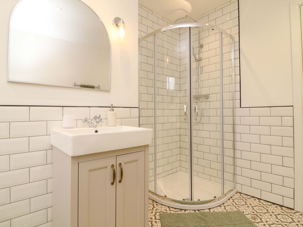 A bathroom with a wash basin and a shower at 14 Crown terrace Belper