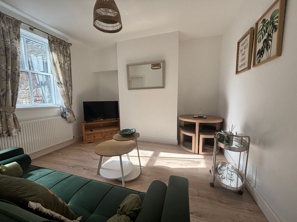 A living room with a sofa and television at Crown Cottage in Belper