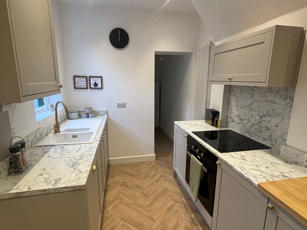 A kitchen with a sink and countertop at Crown Cottage in Belper
