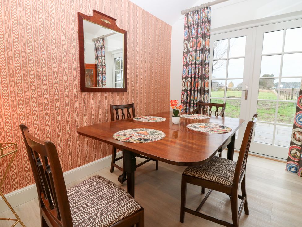 A dining room with a table and chairs at 4 East Camno Farm Cottages Near Meigle